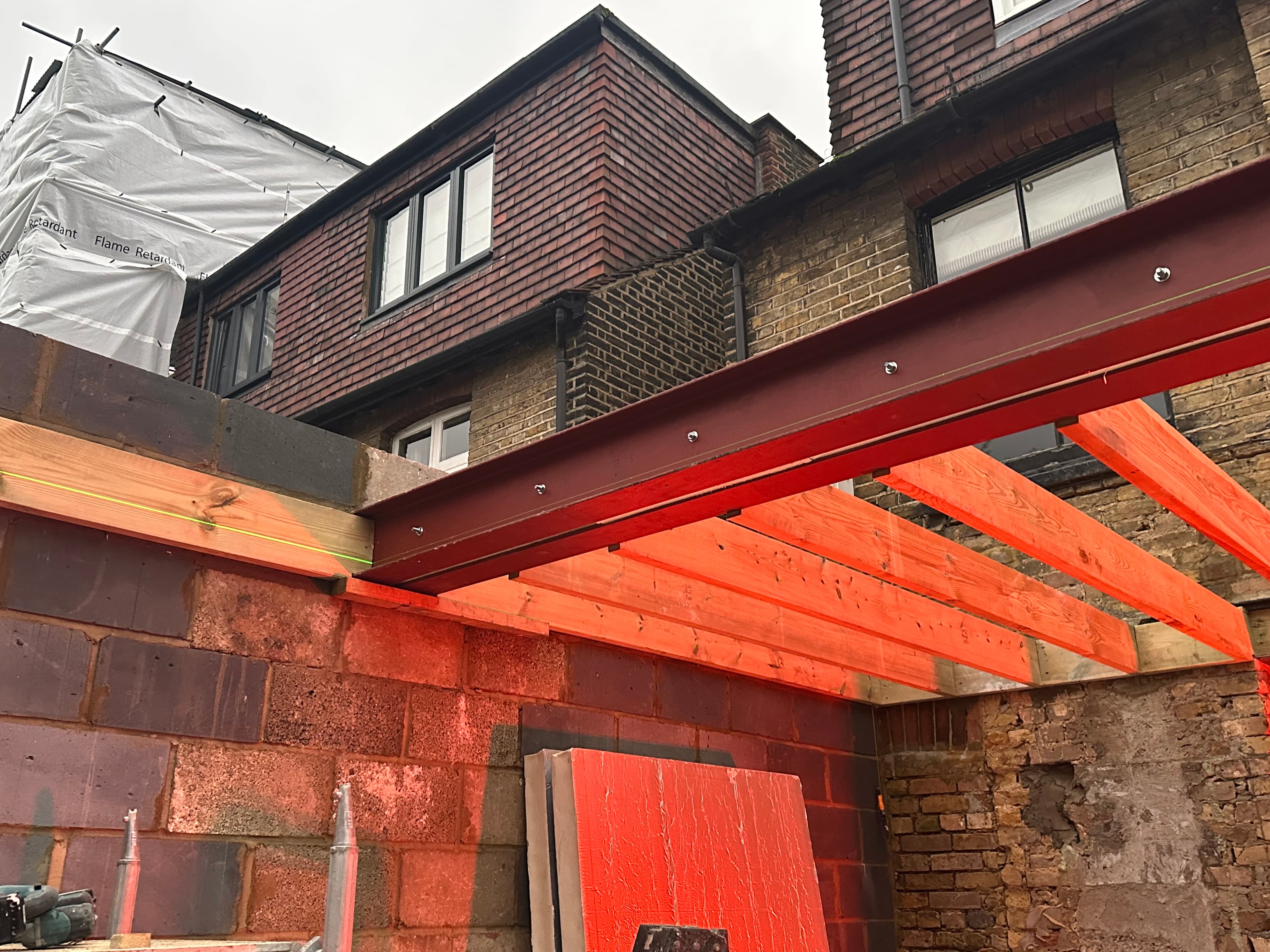 Steel beam installation across the existing floor void.