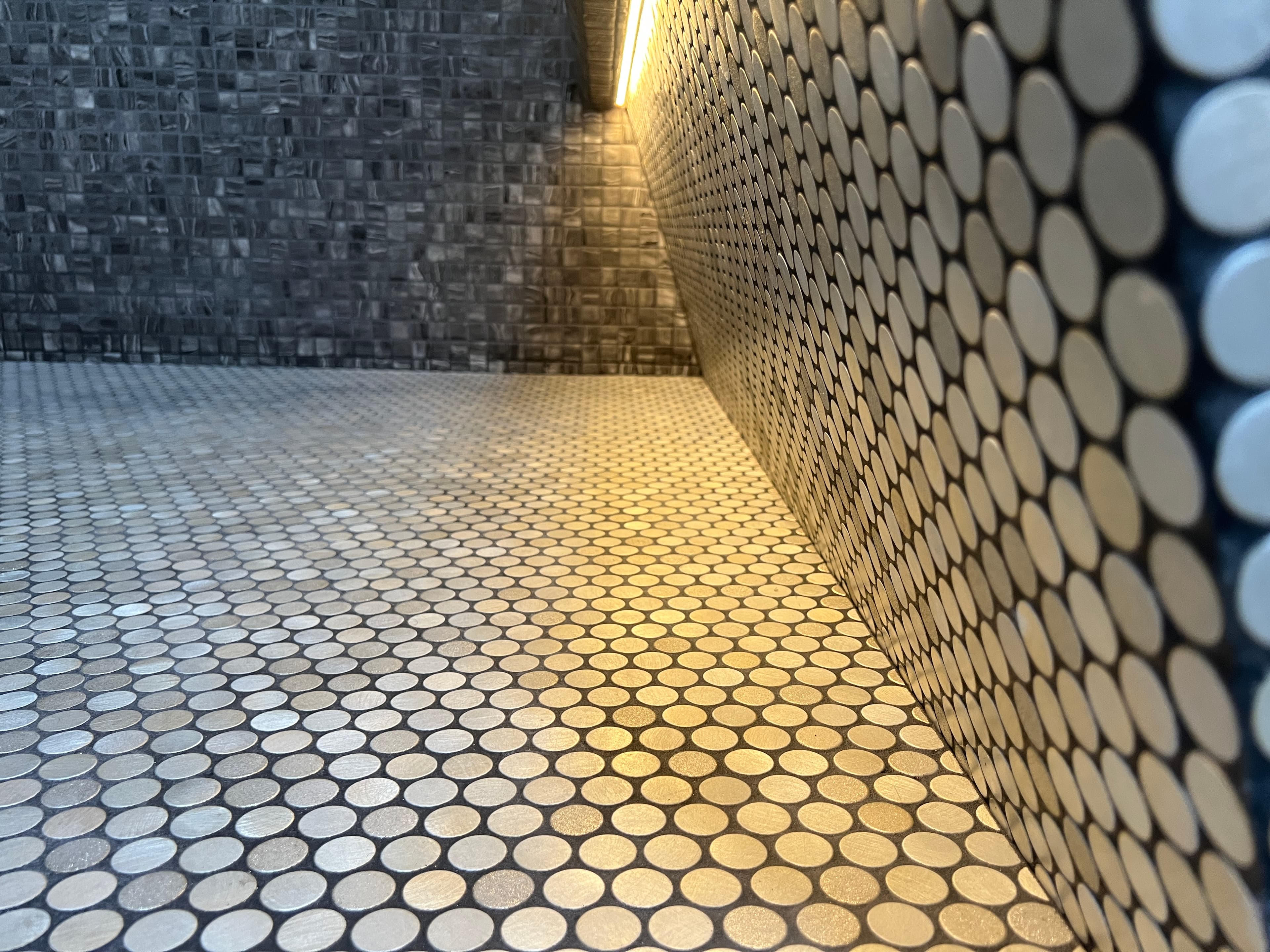 Close-up craftsmanship bench showing bespoke joinery and metal edge details.